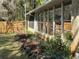 Enclosed porch with garden beds surrounded by a wooden fence at 24892 Sw Sailboat Dr, Dunnellon, FL 34431