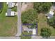 An aerial view of a charming home surrounded by lush greenery and mature trees at 25156 Buttonwood Dr # 126, Astatula, FL 34705