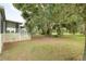 Expansive backyard with a screened-in porch and mature landscaping for outdoor enjoyment at 25156 Buttonwood Dr # 126, Astatula, FL 34705