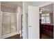 An en-suite bathroom featuring a glass shower and a door leading into the main bedroom at 25156 Buttonwood Dr # 126, Astatula, FL 34705