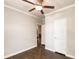 Neutral-toned bedroom with hardwood floors, ceiling fan, and a hallway entrance at 25156 Buttonwood Dr # 126, Astatula, FL 34705