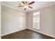Empty bedroom featuring hardwood floors and a window providing plenty of natural light at 25156 Buttonwood Dr # 126, Astatula, FL 34705
