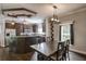 Dining area and kitchen featuring dark wood cabinets, stainless appliances, and decorative ceiling at 25156 Buttonwood Dr # 126, Astatula, FL 34705