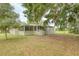 Charming home with a screened porch and well-maintained lawn, perfect for outdoor living at 25156 Buttonwood Dr # 126, Astatula, FL 34705