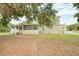 Well-maintained home exterior with a screened porch and a lush, green lawn at 25156 Buttonwood Dr # 126, Astatula, FL 34705