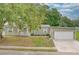 Charming single-story home featuring an attached garage and well-maintained landscaping at 25156 Buttonwood Dr # 126, Astatula, FL 34705