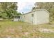 Home exterior showing a screened porch and green lawn, surrounded by trees and shrubbery at 25156 Buttonwood Dr # 126, Astatula, FL 34705