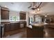Kitchen featuring dark wood cabinetry, stainless steel appliances, breakfast bar, and open layout at 25156 Buttonwood Dr # 126, Astatula, FL 34705