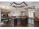Kitchen and dining area featuring dark wood cabinetry, breakfast bar, and open layout at 25156 Buttonwood Dr # 126, Astatula, FL 34705
