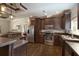 Well-equipped kitchen with stainless steel appliances, dark wood cabinetry, and a breakfast bar at 25156 Buttonwood Dr # 126, Astatula, FL 34705