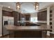 Well-equipped kitchen with dark wood cabinetry, stainless steel appliances, and a breakfast bar at 25156 Buttonwood Dr # 126, Astatula, FL 34705
