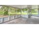 Spacious screened porch with wood flooring and views of the lush surrounding landscape at 25156 Buttonwood Dr # 126, Astatula, FL 34705