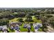 Aerial view of a neighborhood that backs up to a lush green golf course at 25406 Crestwater Dr, Leesburg, FL 34748