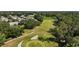 Aerial view of community featuring mature trees and lush golf course at 25406 Crestwater Dr, Leesburg, FL 34748