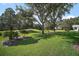The property features a large, well-manicured lawn with mature trees at 25406 Crestwater Dr, Leesburg, FL 34748