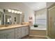 Bright bathroom featuring double sinks, a soaking tub, and a separate shower, offering convenience and luxury at 25406 Crestwater Dr, Leesburg, FL 34748