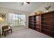 Bedroom with a vaulted ceiling, a large window, and built-in bookshelves, offering ample storage and natural light at 25406 Crestwater Dr, Leesburg, FL 34748