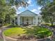 Elegant community clubhouse with grand entrance, manicured landscaping, and ample parking at 25406 Crestwater Dr, Leesburg, FL 34748