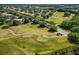 Aerial view of the golf course, with a meandering path for carts and trees dotting the landscape at 25406 Crestwater Dr, Leesburg, FL 34748