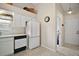 Clean, white kitchen includes appliances, ample counter space, tiled floors and plenty of lighting at 25406 Crestwater Dr, Leesburg, FL 34748