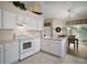 Well-lit kitchen featuring white cabinetry, tile floors, and modern appliances, perfect for cooking and entertaining at 25406 Crestwater Dr, Leesburg, FL 34748
