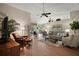 Bright living room with vaulted ceilings, fan, wood floors, comfortable seating, and decor at 25406 Crestwater Dr, Leesburg, FL 34748