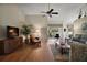 Spacious living room with wood floors, vaulted ceilings, and access to a screened patio at 25406 Crestwater Dr, Leesburg, FL 34748