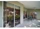 Covered patio area features sliding glass doors to the yard and multiple seating options at 25406 Crestwater Dr, Leesburg, FL 34748