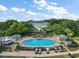 Resort-style pool and clubhouse offer a luxurious community gathering place, complete with lush landscaping at 25406 Crestwater Dr, Leesburg, FL 34748