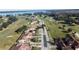 Aerial view of the community, showcasing the golf course and lake at 26612 Bella Vista Dr, Howey In The Hills, FL 34737