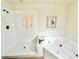 White bathroom featuring a walk-in shower and whirlpool tub with gold fixtures at 26612 Bella Vista Dr, Howey In The Hills, FL 34737
