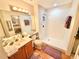 Bright bathroom featuring a walk-in shower, vanity with a sink, and a large mirror at 26612 Bella Vista Dr, Howey In The Hills, FL 34737