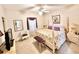 Comfortable bedroom with neutral tones, ceiling fan, and ensuite bathroom access at 26612 Bella Vista Dr, Howey In The Hills, FL 34737