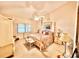 Comfortable bedroom with a canopy bed, ceiling fan, and soft lighting at 26612 Bella Vista Dr, Howey In The Hills, FL 34737