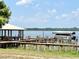 Waterfront view of the community dock with a covered seating area and boat slip at 26612 Bella Vista Dr, Howey In The Hills, FL 34737