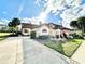 Charming home with a tile roof, manicured landscaping, and a sunny curb appeal at 26612 Bella Vista Dr, Howey In The Hills, FL 34737