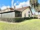 Well-maintained exterior with tile roof, manicured landscaping, and screened-in porch at 26612 Bella Vista Dr, Howey In The Hills, FL 34737