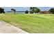 Scenic view of the golf course with a green in the distance near a lake at 26612 Bella Vista Dr, Howey In The Hills, FL 34737
