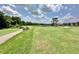 Golf course view with a path and sand trap leading to the green and a clubhouse at 26612 Bella Vista Dr, Howey In The Hills, FL 34737