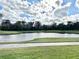 Scenic view of the golf course and pond, offering a peaceful and picturesque setting at 26612 Bella Vista Dr, Howey In The Hills, FL 34737