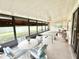 Enclosed lanai with multiple seating areas, game tables, and scenic views, perfect for entertaining or relaxing at 26612 Bella Vista Dr, Howey In The Hills, FL 34737