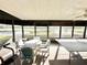 Enclosed lanai featuring furniture and a ping pong table with views of the golf course at 26612 Bella Vista Dr, Howey In The Hills, FL 34737