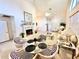 Open-concept living area with a fireplace, dining table, and comfortable seating at 26612 Bella Vista Dr, Howey In The Hills, FL 34737