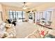 Bright living room with comfortable seating, entertainment center, and access to an enclosed patio at 26612 Bella Vista Dr, Howey In The Hills, FL 34737
