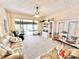 Cozy living room featuring neutral carpet, sliding glass doors and comfortable seating at 26612 Bella Vista Dr, Howey In The Hills, FL 34737