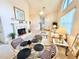 Bright living room with high ceilings, a cozy fireplace, and comfortable seating arrangement at 26612 Bella Vista Dr, Howey In The Hills, FL 34737