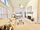 Bright living room with vaulted ceilings, neutral carpet, fireplace, and large windows at 26612 Bella Vista Dr, Howey In The Hills, FL 34737