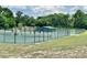 Full view of the community tennis courts, fenced and in a park-like setting at 26612 Bella Vista Dr, Howey In The Hills, FL 34737