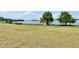 Waterfront view showcasing the lush green lawn and access to the lake at 26612 Bella Vista Dr, Howey In The Hills, FL 34737