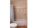 Bathroom features a shower and tub combination, tiled walls, and neutral color at 2701 S Dellwood Dr, Eustis, FL 32726